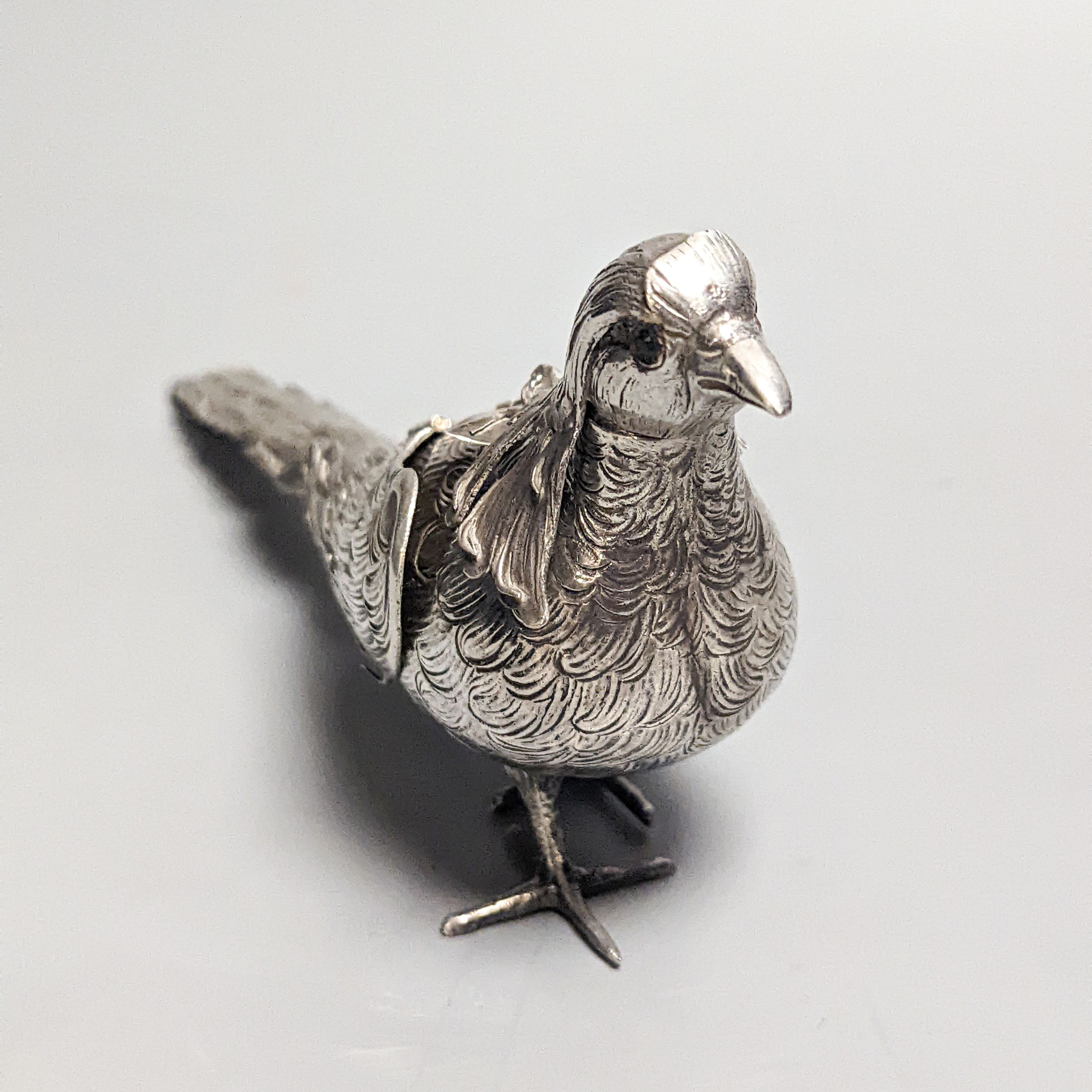 A late 19th century Hanau 800 white metal novelty condiment?, modelled as a game bird, with articulated wings and removable head, 22.4cm, gross 139 grams.